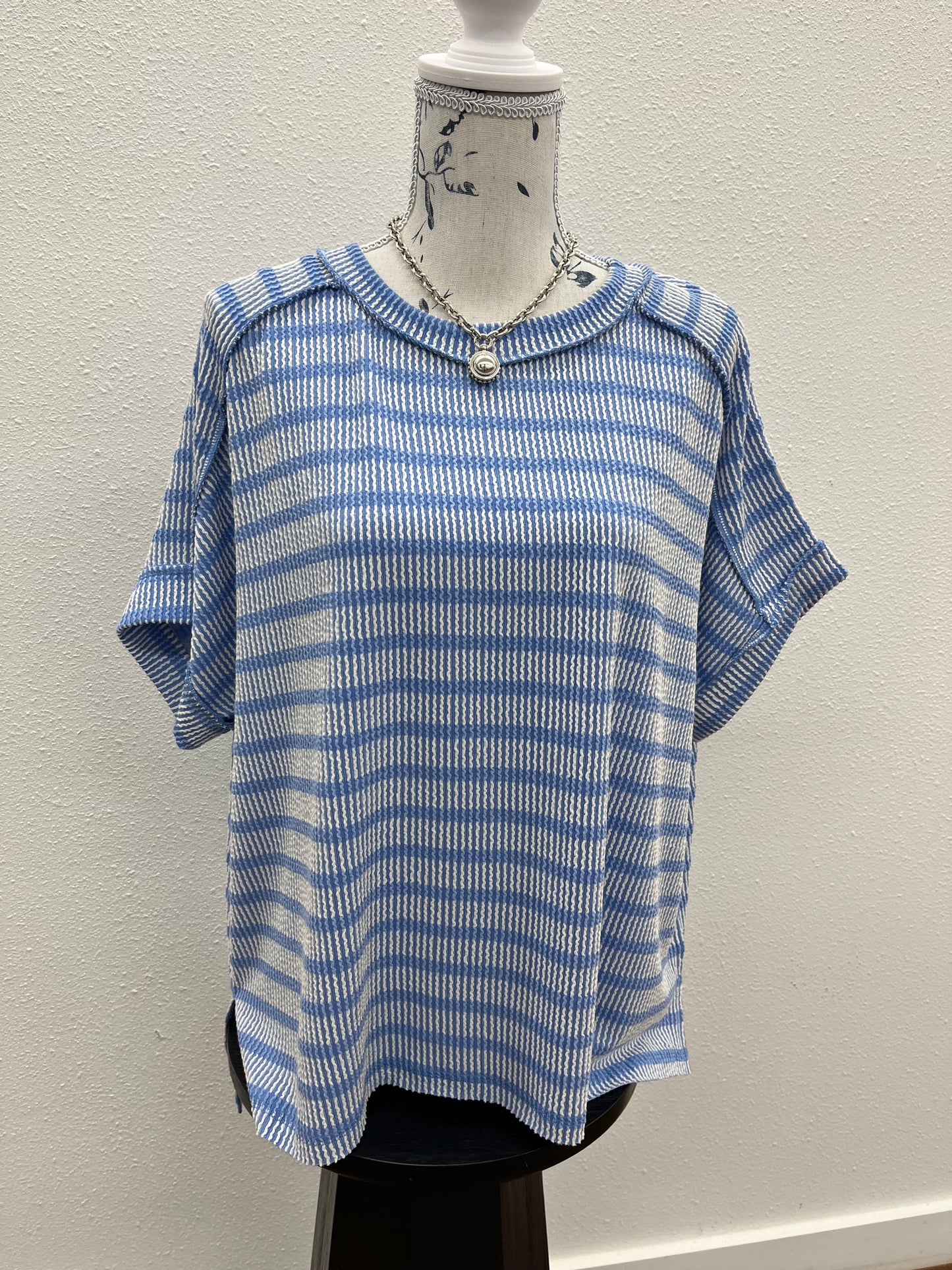Raised rib striped exposed seam top