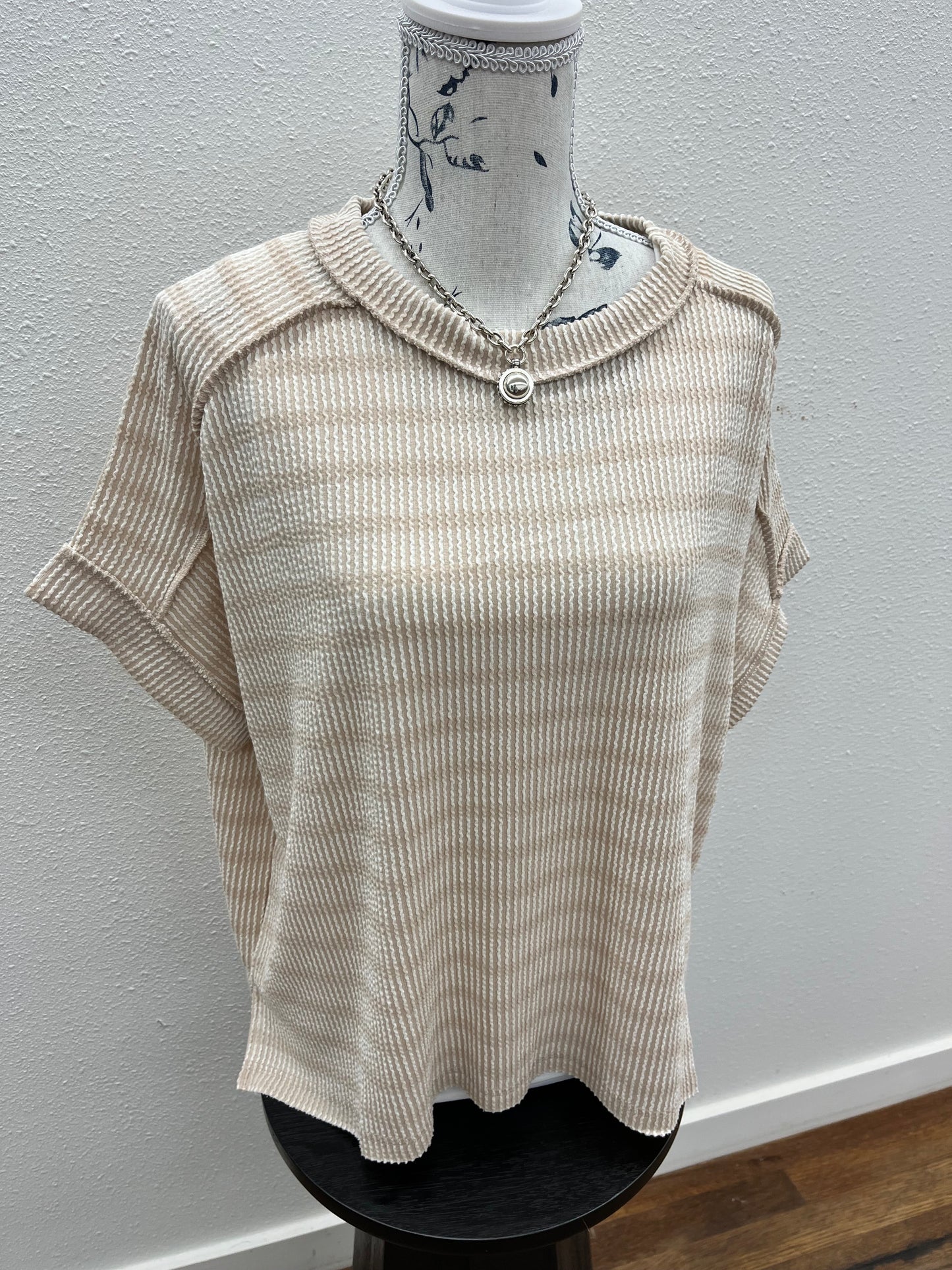 Raised rib striped exposed seam top
